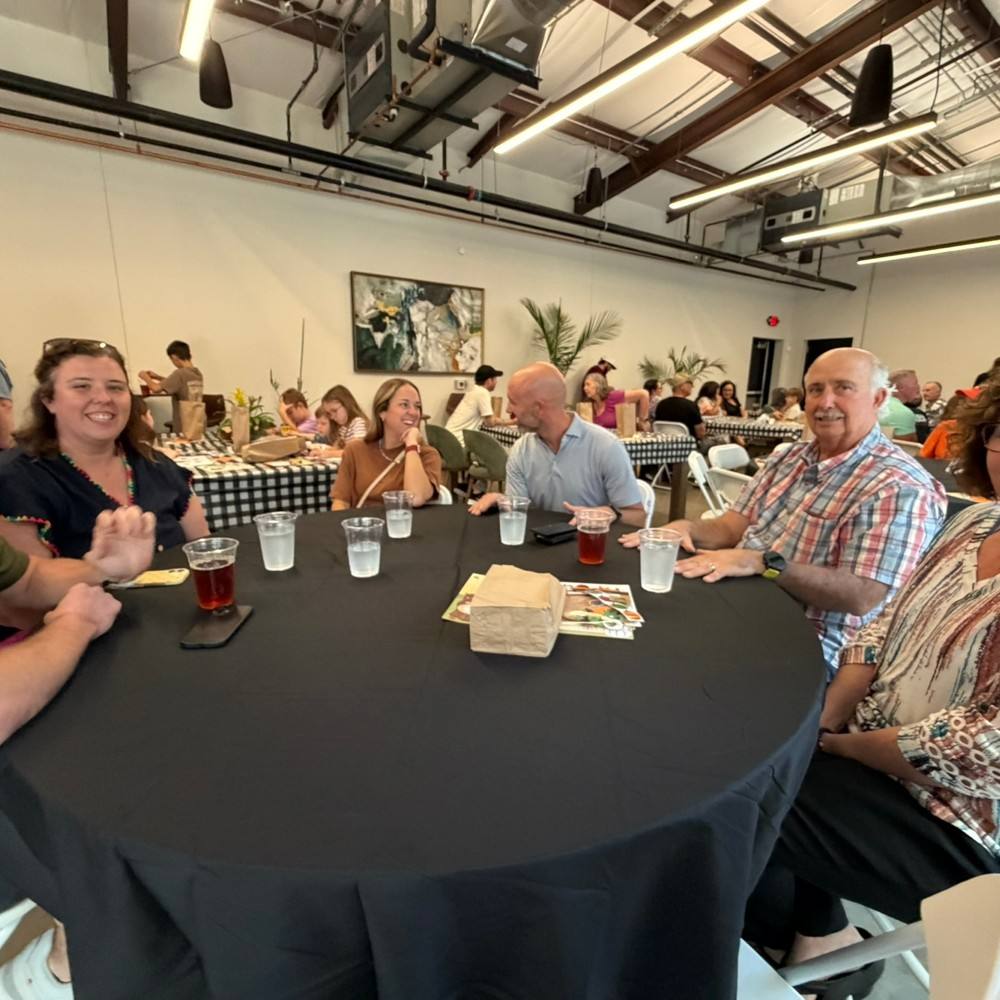 Refuge adults gathered around a table